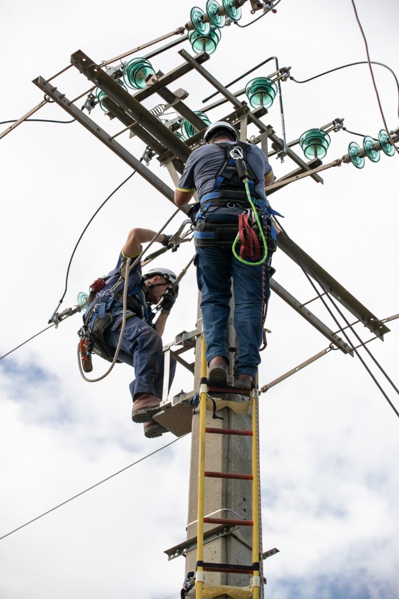 Two technicians on an electric pole